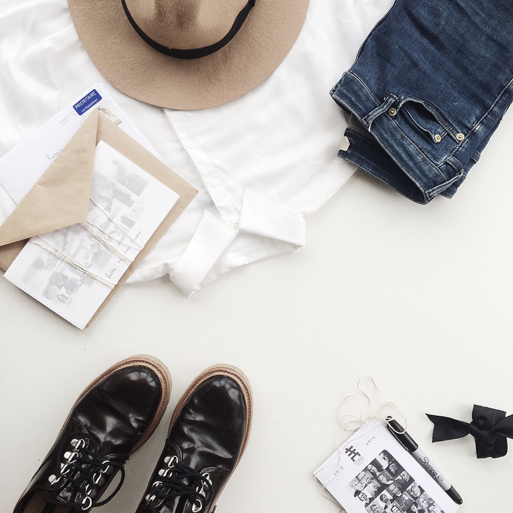 White Dress Shirt Near Blue Jeans and Envelope on Table